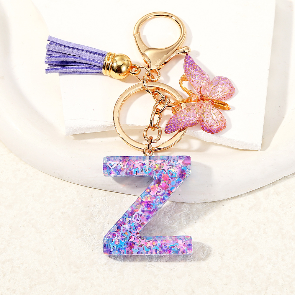 Mayorista transfronterizo mariposa esquinilla iniciales llavero de cristal goteo llavero de letras bolsos colgante