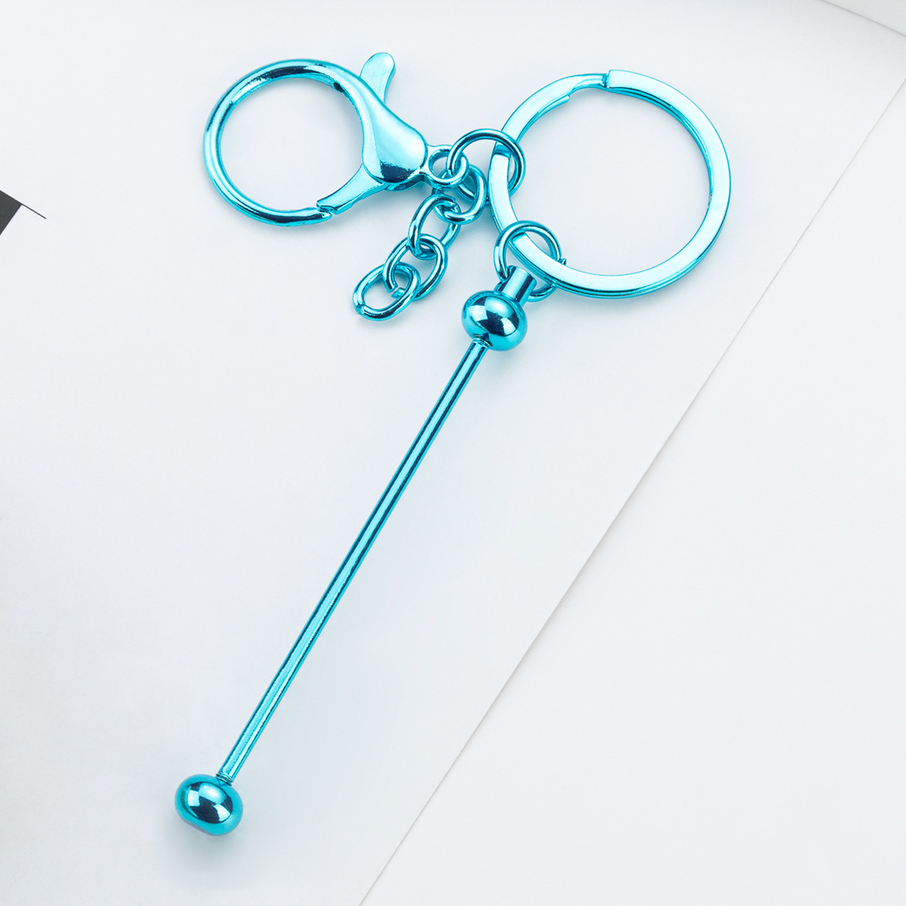 DIY cuentas llaveros auriculares caja de teléfono celular colgante llaveros de metal chapeado UV llaveros al por mayor spot