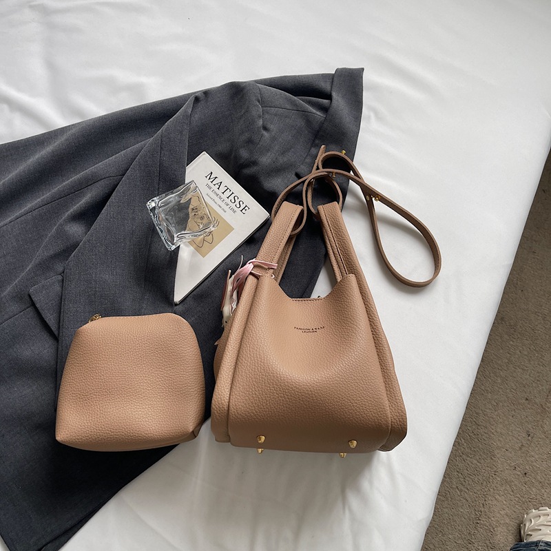 Este año popular simple bolso de cubo portátil para mujeres 2026 nuevo estilo de alto nivel lichi estampado lujoso mochila de hombro