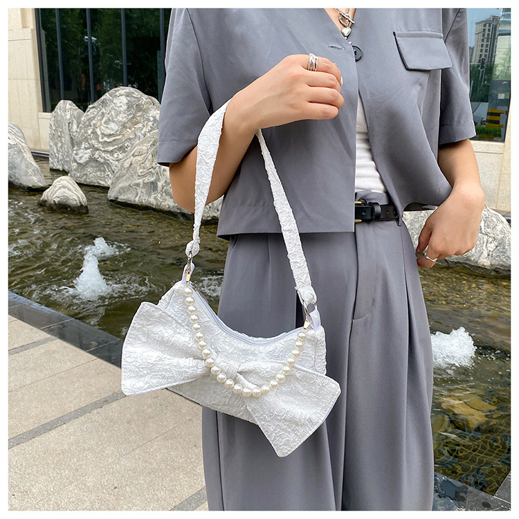 Bowknot Solid Color Pearl Chain Folds Single Shoulder Messenger Underarm Bag Wholesale Nihaojewelry display picture 1