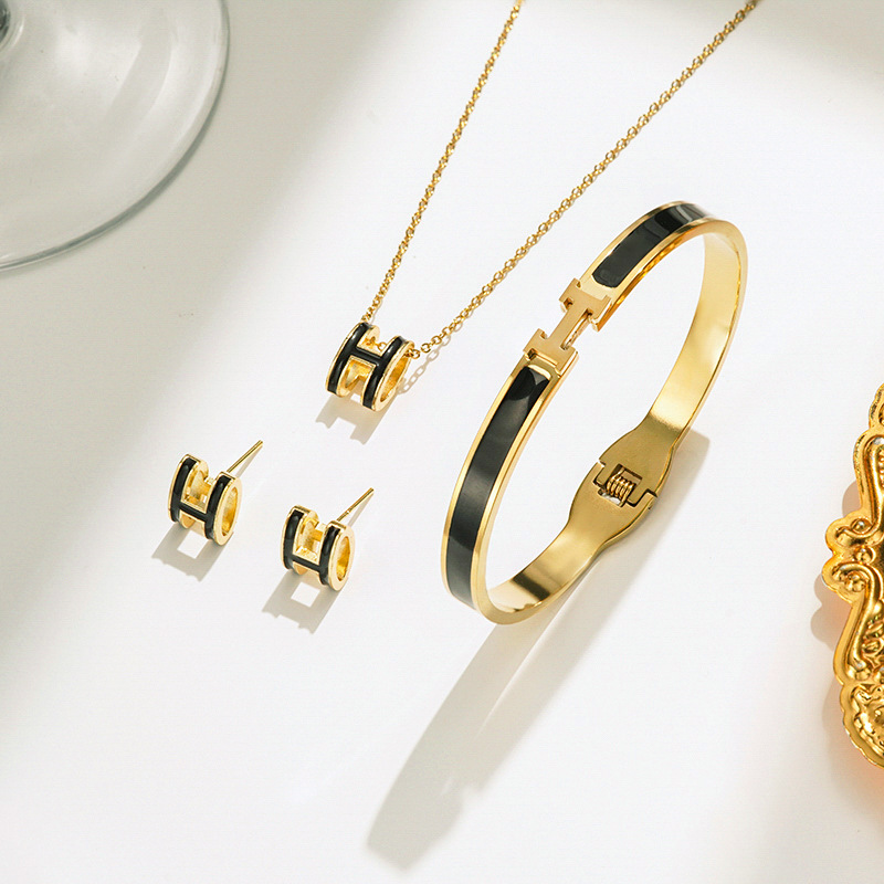 Gold and black necklace earrings bracelet