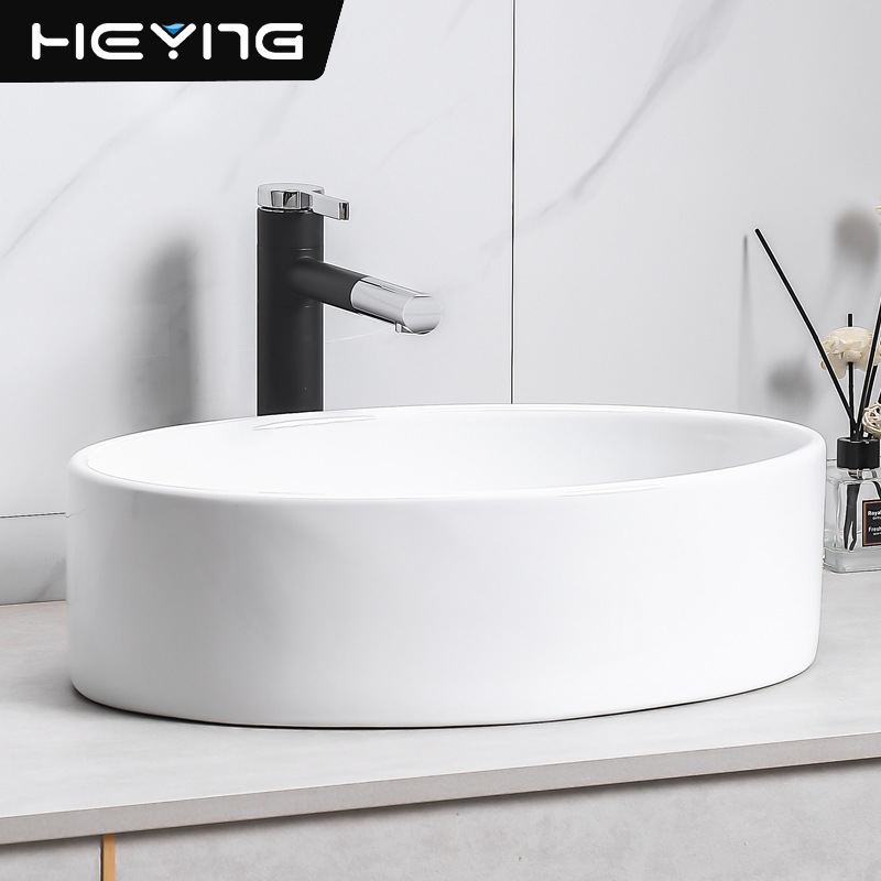 lavabo de cerámica simple elíptico en la mesa de arte lavabo pequeño tipo de lavabo fábrica de lavabo único al por mayor image 2