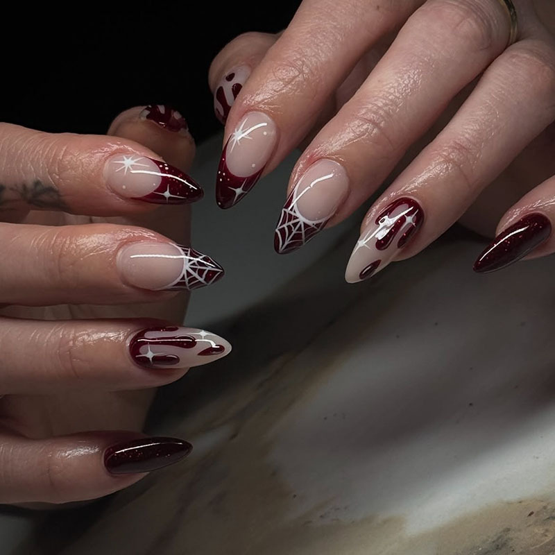 Long pointed red French nails with spider web, blood drops, and star patterns, gothic style Halloween fake nails