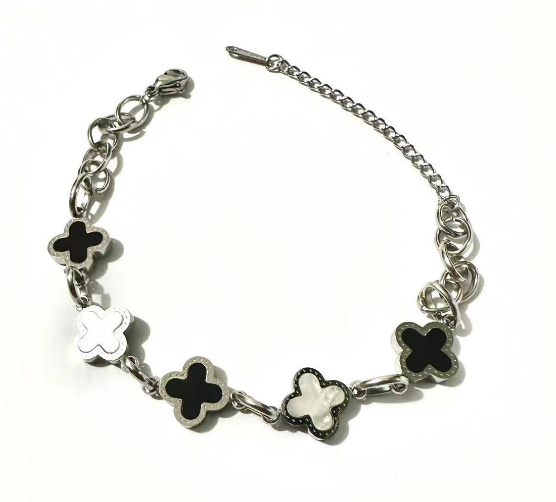 Pulsera de trébol de acero titanium vendedora caliente transfronteriza europea y americana con incrustaciones de concha pulsera colgante pulsera de diseño avanzado sin desvanecimiento al por mayor