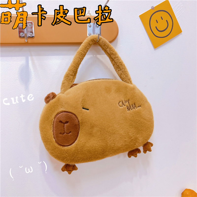 Bolso de peluche en línea para mujeres 2025 nuevo bolso de muñeca Capibara, bolso de cubo de mano lindo corazón de niña