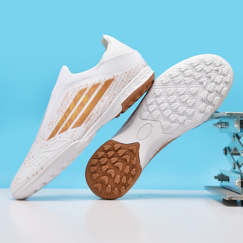 New cross-border model F50 low-top laceless non-slip soft-soled football shoes with long spikes for artificial turf training