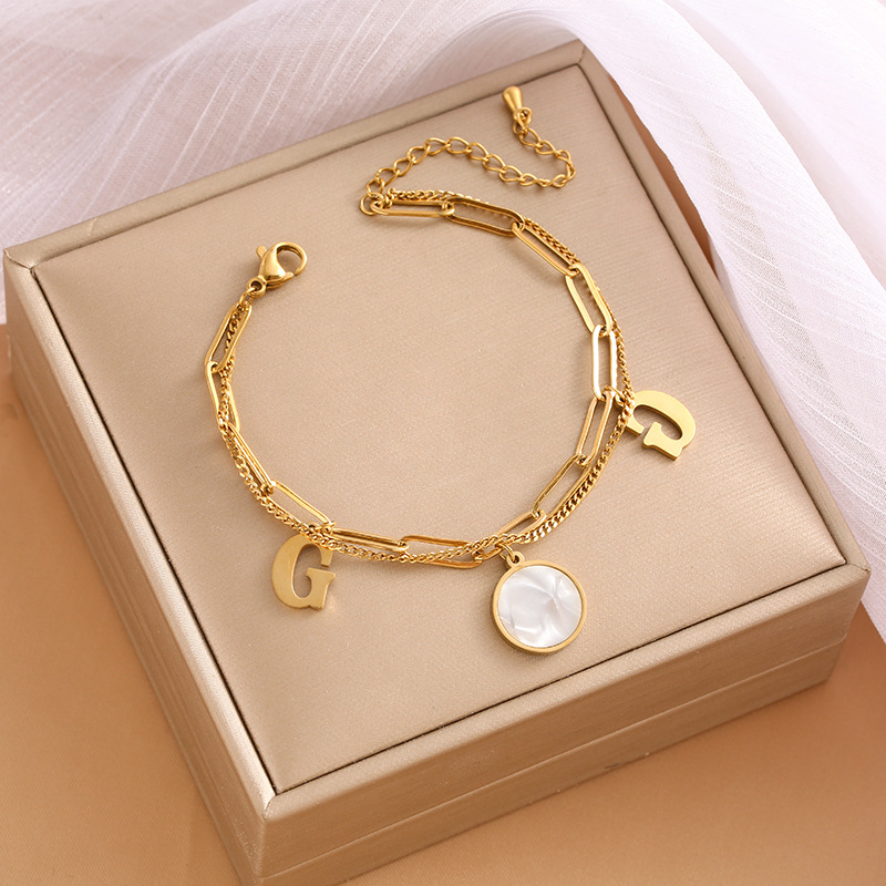 Pulsera de trébol de acero titanium vendedora caliente transfronteriza europea y americana con incrustaciones de concha pulsera colgante pulsera de diseño avanzado sin desvanecimiento al por mayor