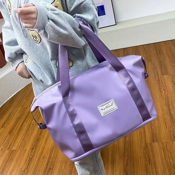 Capacious handheld luggage folding storage bag for traveling