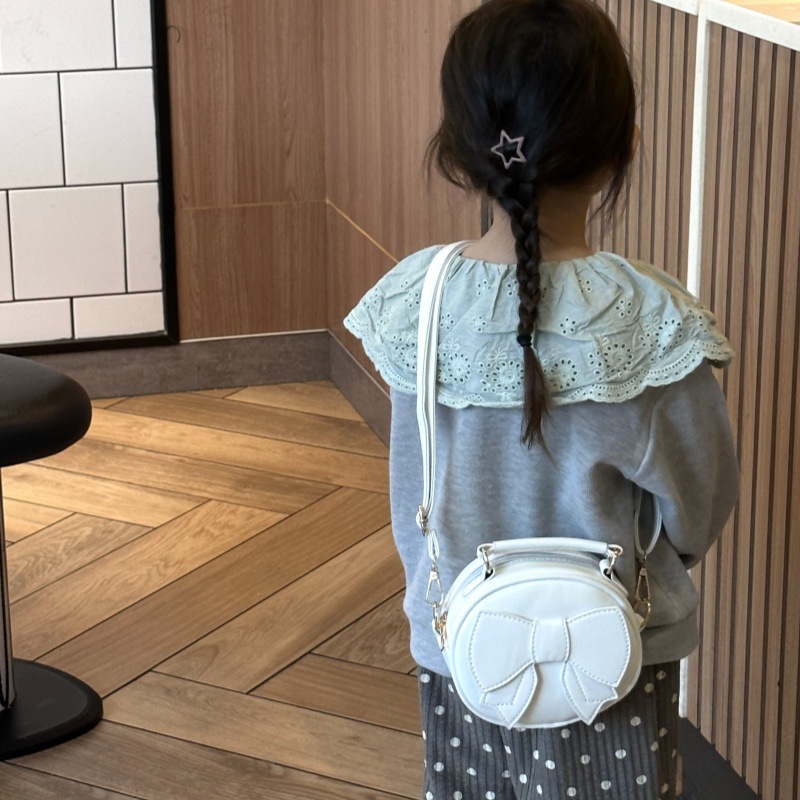 Bolsos para niños mini lindos arcos para hombres y mujeres, bolsos redondos para niños 2025 moda coreana nueva bolsa de cambio para niños