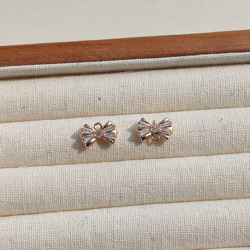 Copper earrings with zircon with bow