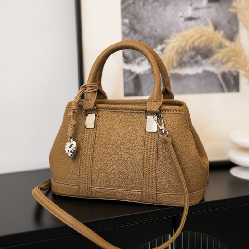 Versión coreana del bolso de nicho 2025 verano nuevo bolso femenino retro patrón de lichi bolso de hombro diario mensajero de viaje