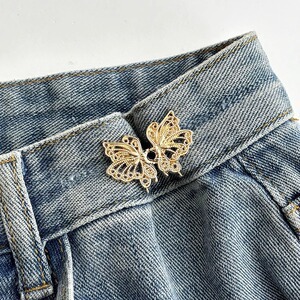 Pantalones de jeans de cintura, botones de cintura ajustados, botones ajustables fijos