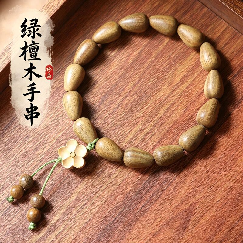 Green sandalwood water drop bead bracelet, wooden plum blossom tassel pendant, new Chinese style sandalwood bracelet, traditional Chinese style natural wood jewelry Green sandalwood water drop bead bracelet, wooden plum blossom tassel pendant, new Chinese style sandalwood bracelet, traditional Chinese style natural wood jewelry