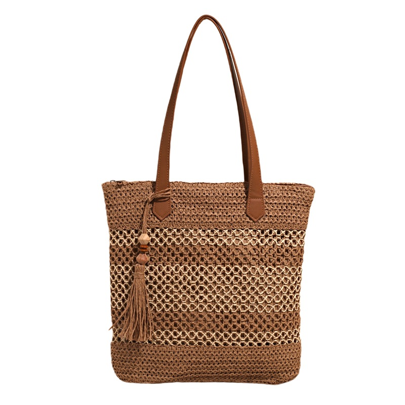 2025 nuevo bolso de cubo portátil de tendencia a cuadros, bolso de paja hueco de vacaciones junto al mar, bolso de hombro de playa de gran capacidad