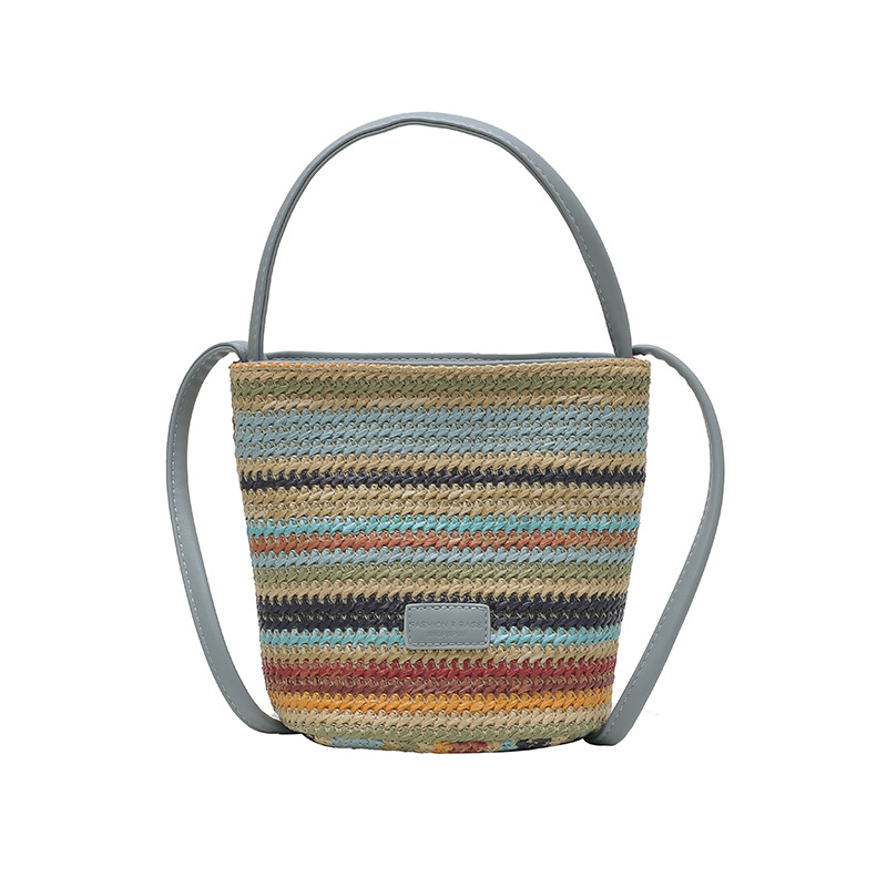Bolso de cubo de vacaciones junto al mar 2025 nuevo bolso de mujer bolso de hombro tejido de paja de playa bolso de mensajero de color de contraste a rayas