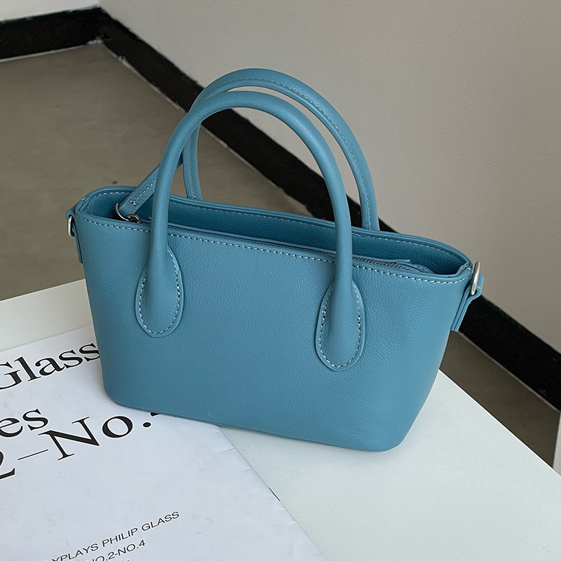 Mini bolsa de cesta de verduras de cuero minimalista 2025 nuevo estilo de piel de vaca Xiaozhong lingote bolso de mensajero portátil bolso de hombro femenino
