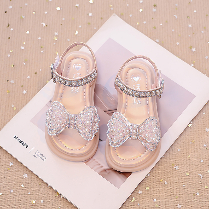 Niños verano 2026 nuevas sandalias de niñas arco brillante con base suave princesa sandalias de viento para niñas sandalias