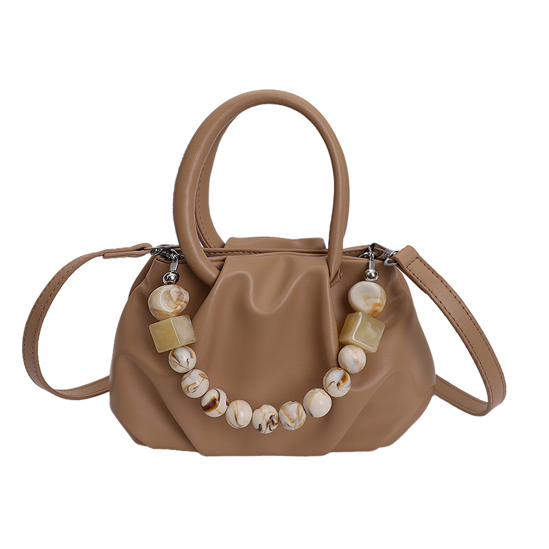Alta sensación de mano pliegueada nube bolso de cubo para mujeres 2026 nuevo nicho de lujo ligero de moda perla bolsa de mochila