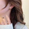 Small sophisticated golden earrings from pearl
