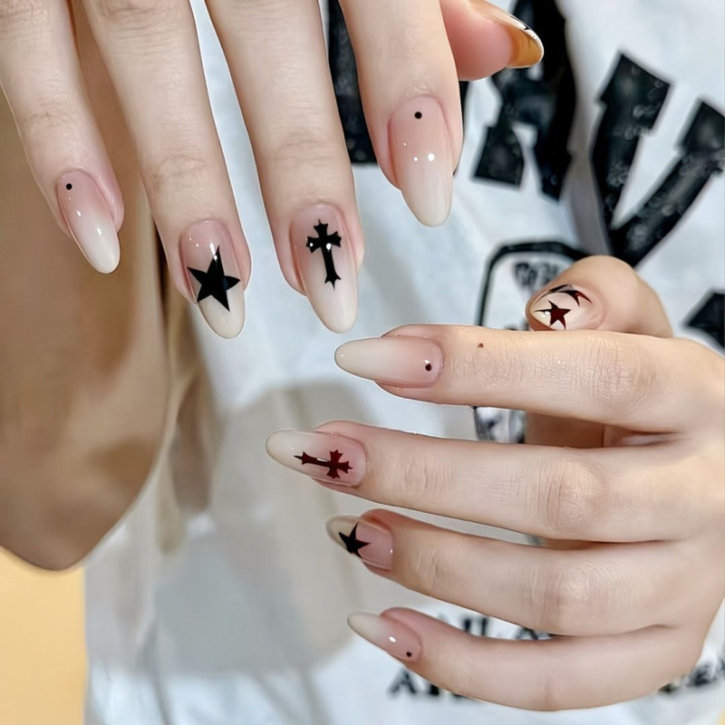 Cool-toned starburst press-on nails with gradient, unique color-blocking, cool and edgy cross design, creating a stylish vibe, with detachable nail pieces