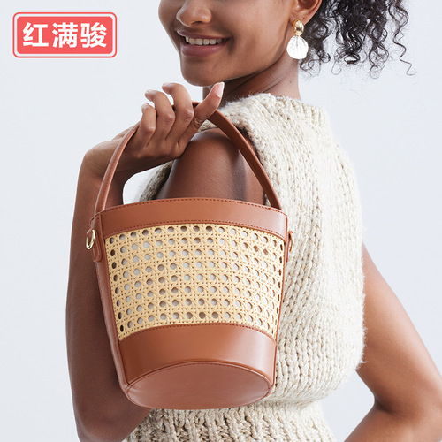 New handmade woven rattan bucket bag for women: chic hollowed-out drawstring tote perfect for beach vacations, also a unique choice as a shoulder or crossbody bag.