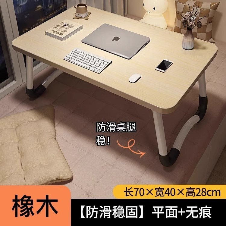折り畳み可能なベッドの上の小さなテーブルは机のノートパソコンのテーブルを勉強します。|undefined