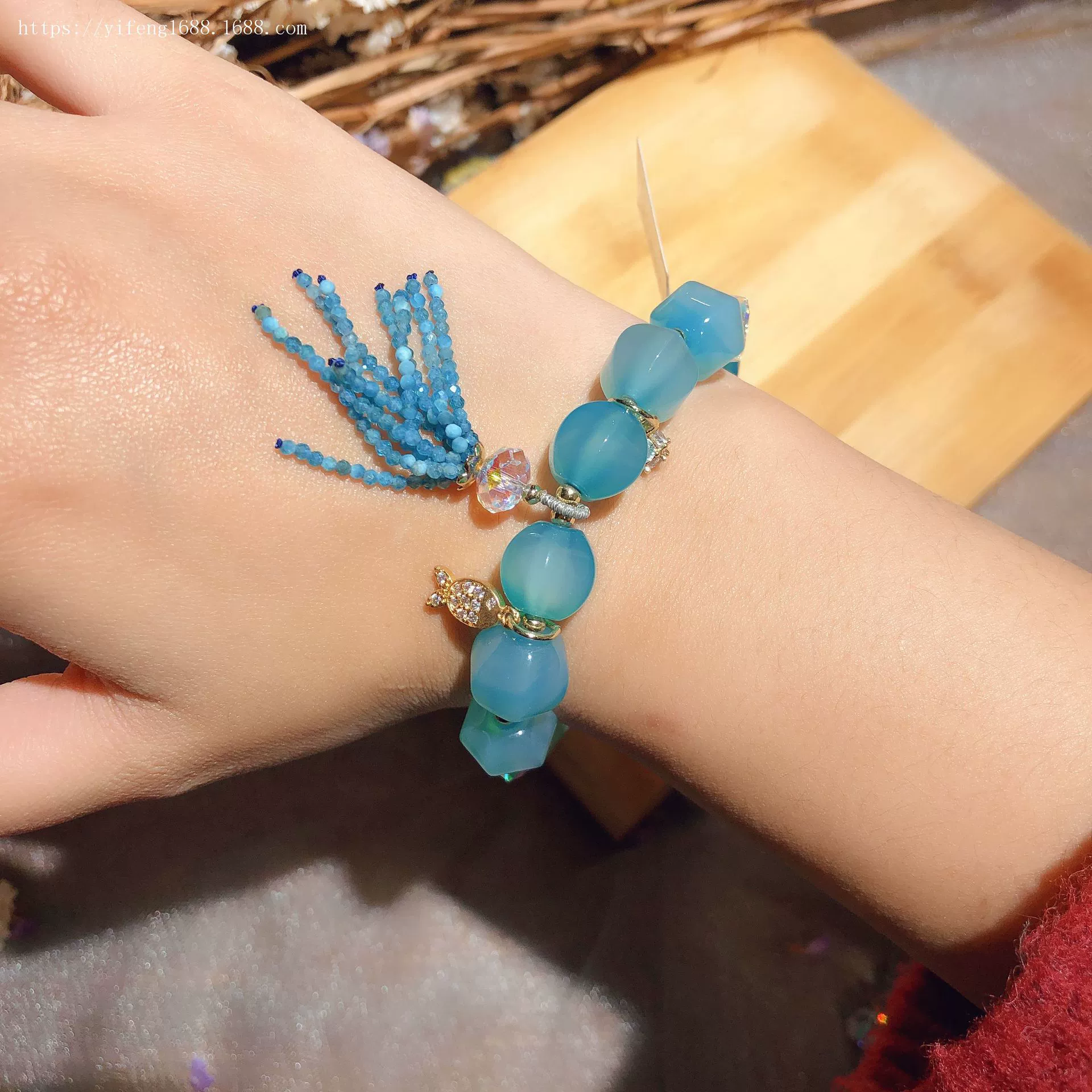 Blue bracelet with tassels, red pendant, accessory