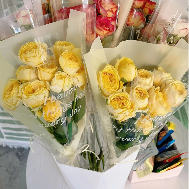 厂家批发七夕情人节透明英文简约鲜花花束包装纸多支装玫瑰向日葵