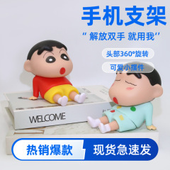 アニメのクレヨンの小さい新しい携帯電話のタブレットのスタンドの子供の頃の怠け者のネットの赤いアニメの手は湿ってかわいい子供の置物を遊びます。
