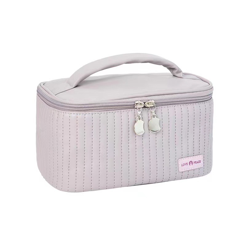 Nueva bolsa de maquillaje de pastel portátil portátil nicho de viaje de alto valor facial adorable bolsa de almacenamiento de cosméticos para productos de cuidado de la piel