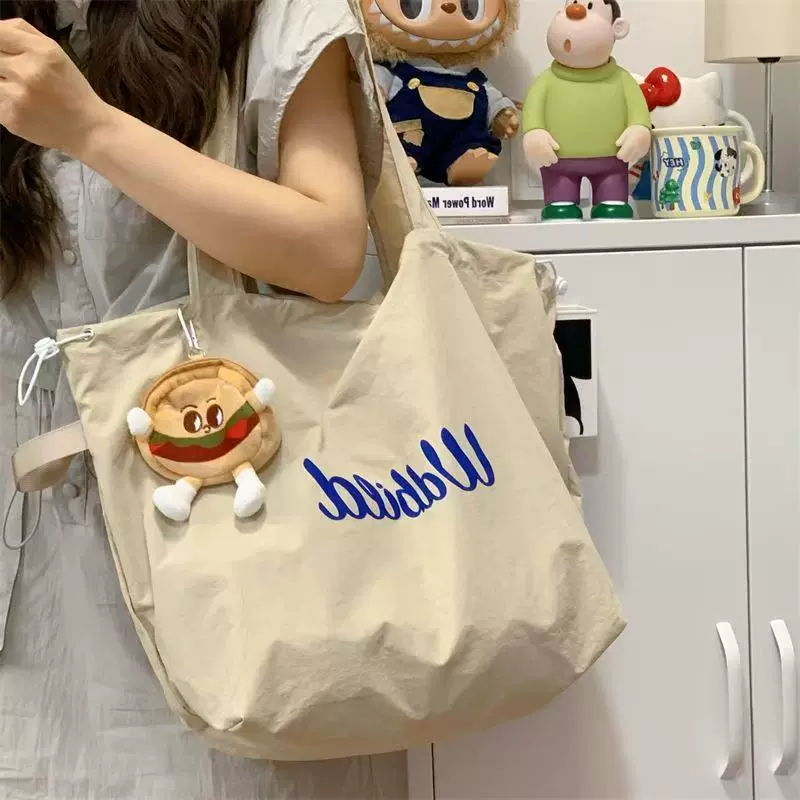 松弛感托特包包女2025新款抽绳帆布包通勤轻便手提袋大容量单肩包