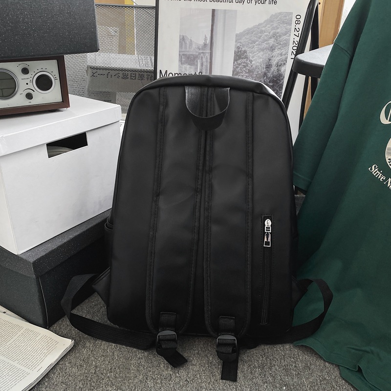 Comercio exterior al por mayor 2023 nueva versión coreana de la mochila de cuero suave para estudiantes de secundaria Mochila de computadora de gran capacidad de color sólido de moda