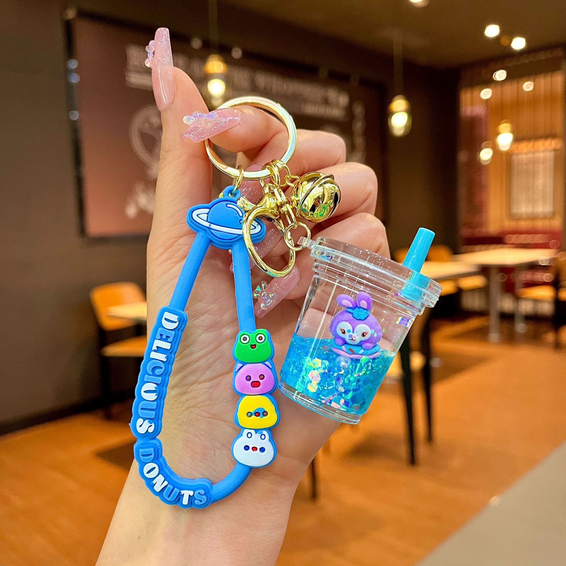 Aceite de gato garra arenas movedizas llavero lindo dibujos animados cadena colgante captura muñeca máquina agarrar pequeño regalo al por mayor