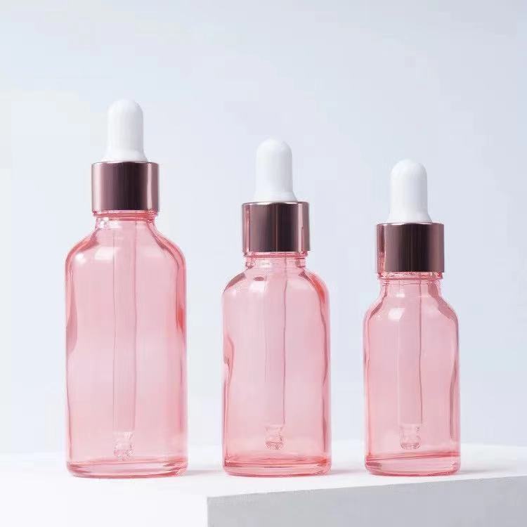 Venta al por mayor 10ml melocotón transparente vidrio Rosa botella de aceite esencial 20ml cosmética sub-botella Rosa anillo de oro botella de vidrio