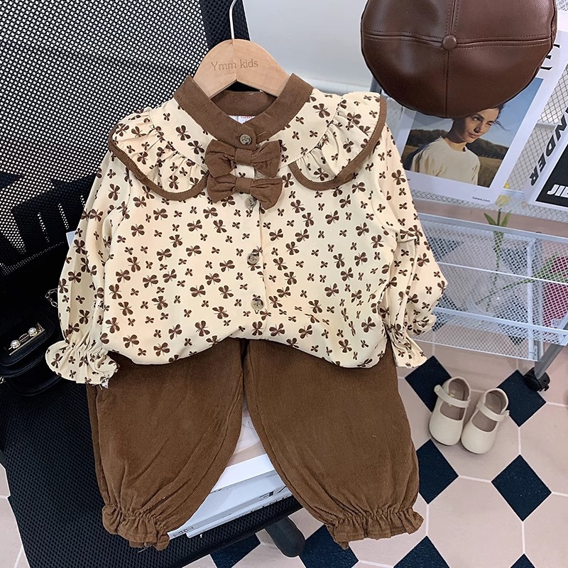 Stylish two-piece set for girls, featuring a cute doll top and casual pants, perfect for toddlers in spring 2025.
