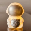 Astronaut holding ball silver