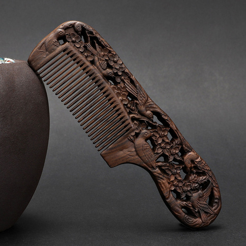 A solid wood hair comb with a black sandalwood handle, double-sided carved floral design, fine-toothed, ancient-style gift comb for smooth hair and massage.