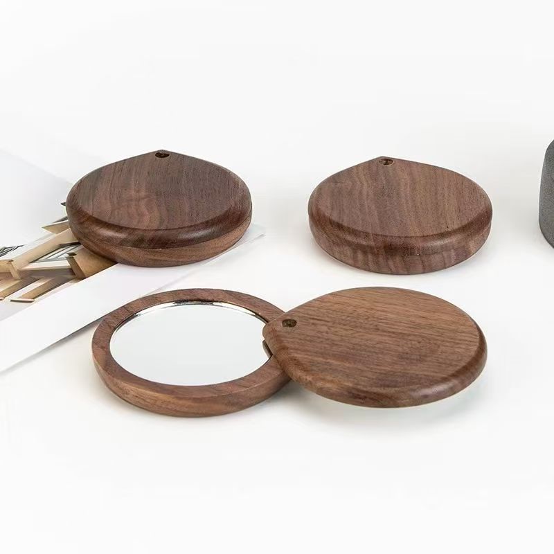 Ventas transfronterizas de nueces negras de alta definición de maquillaje de mano espejo de doble cara espejo de maquillaje de madera giratorio espejo de bolsillo portátil
