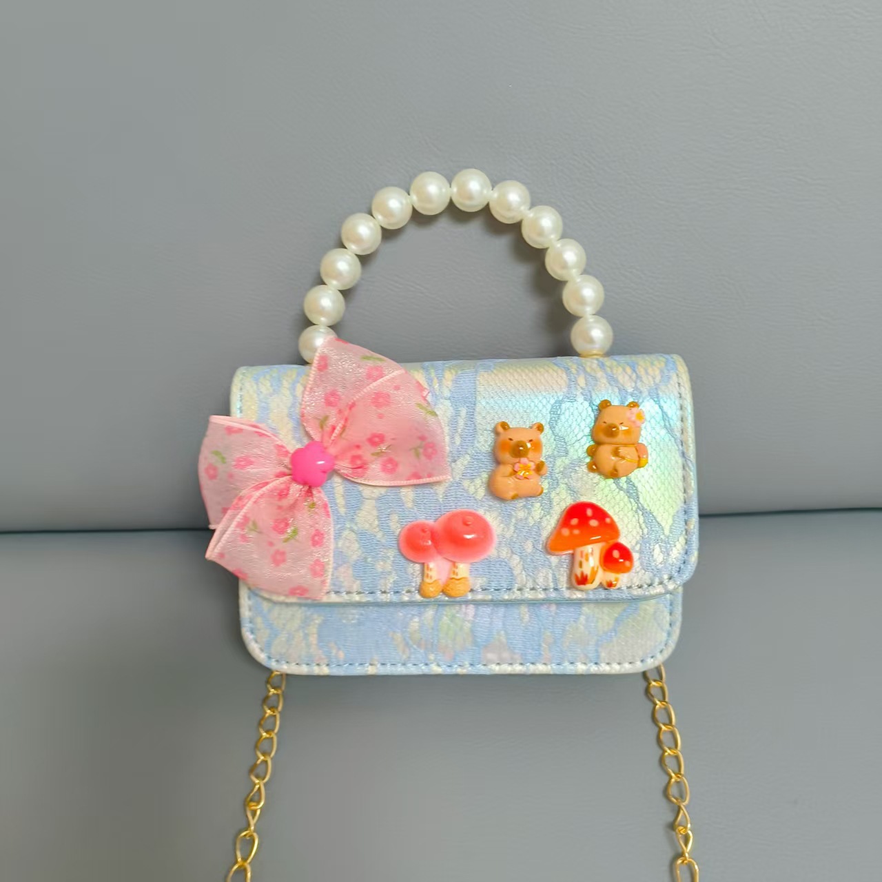 Bolsos para niños nuevos bolsos de perlas de arco para niñas bolsos de cinturón de estilo de fragancia bolsos de cadena bolsos de cambio bolsos