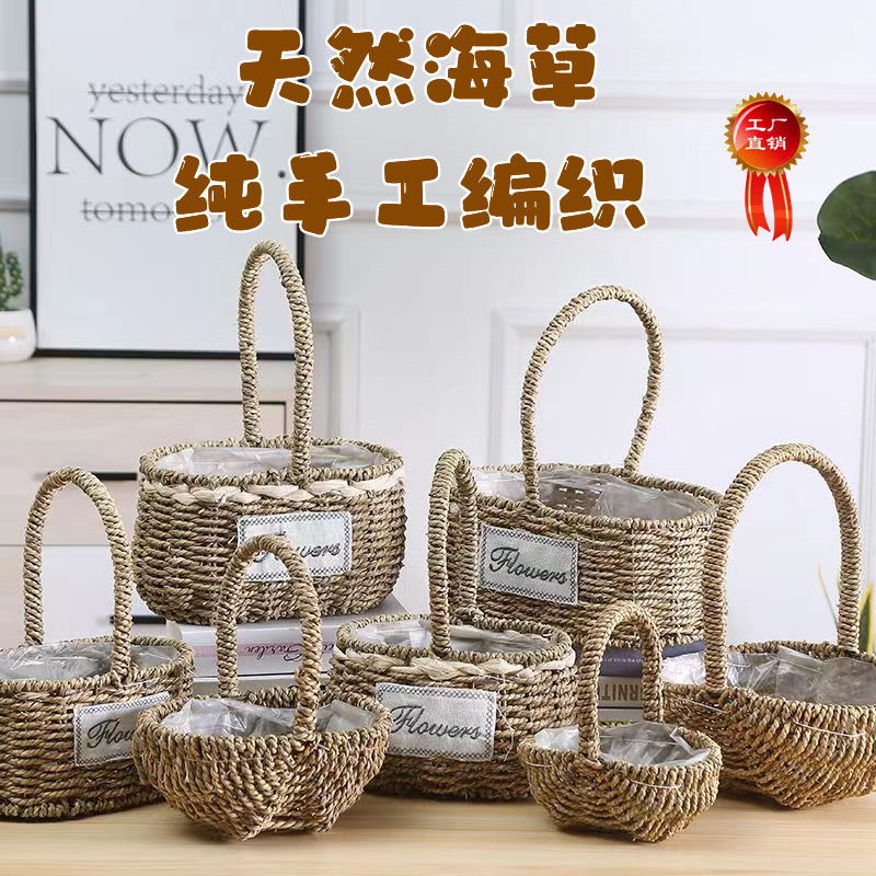 Fabricantes de cestas de flores ovales rectas de paja hechas a mano en stock al por mayor cestas de flores de paja portátiles decoración de viento pastoral
