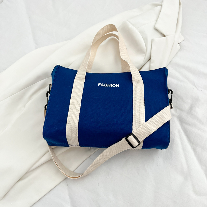 2024 nuevo simple japonés blanco y negro bolso de tela de gran capacidad para estudiantes de clase de viaje mochila de hombro