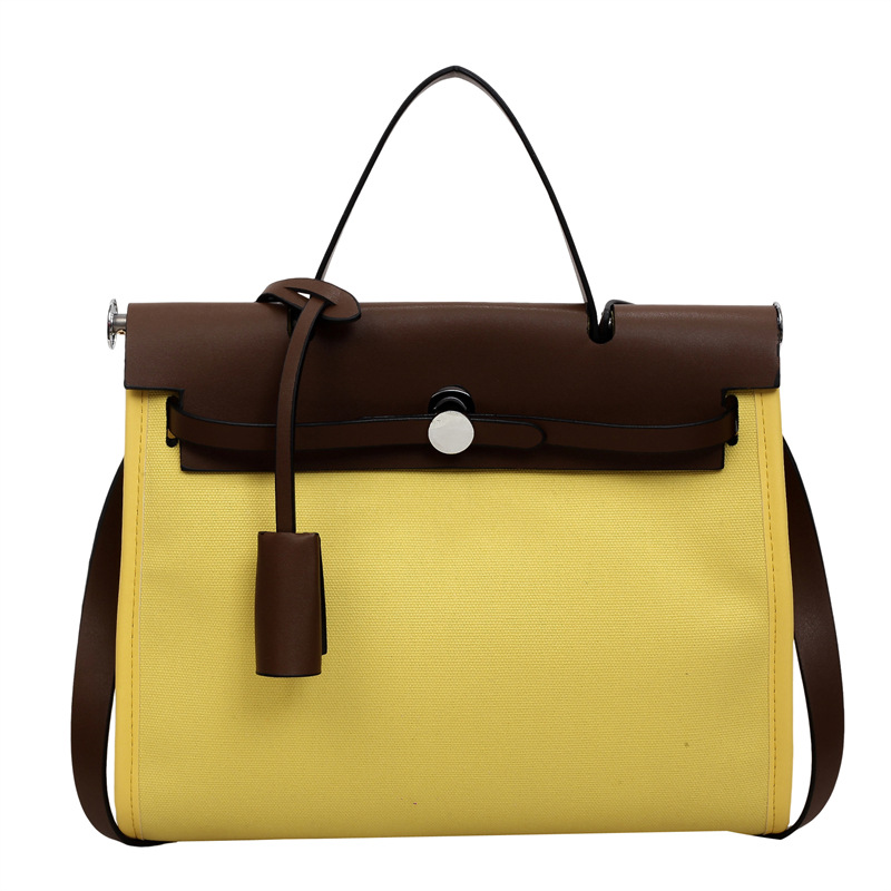 Nicho de moda portátil Kelly bolso mujer 2026 nuevo cross-border lienzo empalme color contraste viaje mochila de hombro