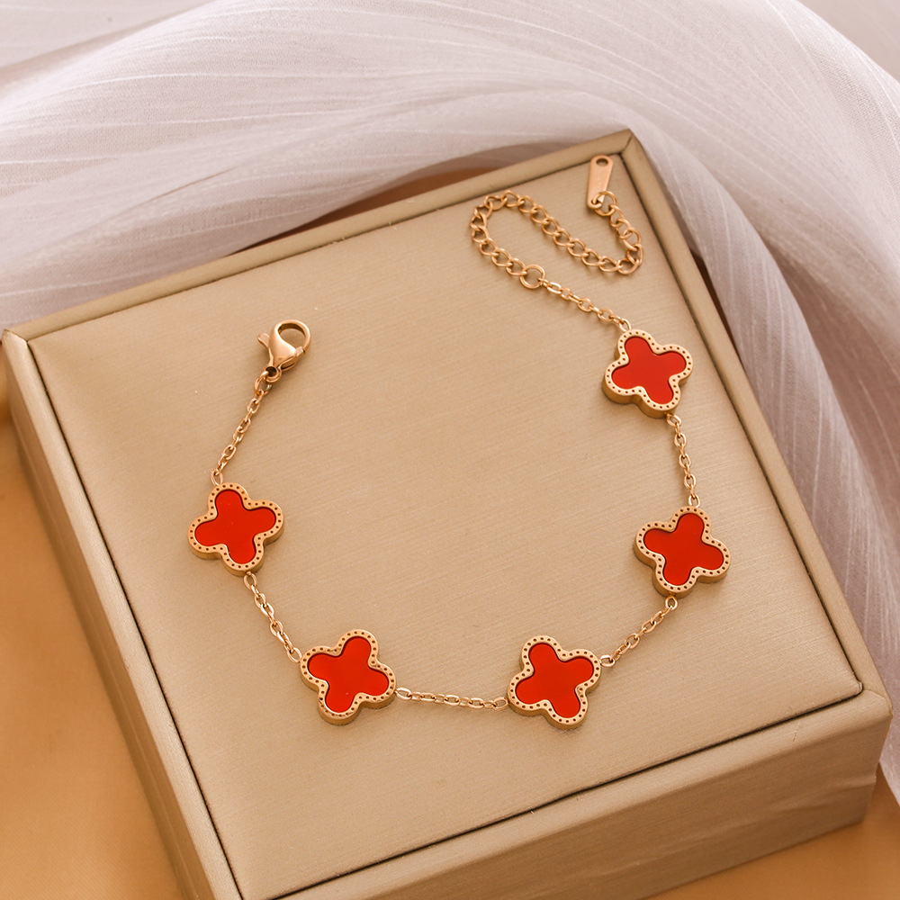 Pulsera de trébol de acero titanium vendedora caliente transfronteriza europea y americana con incrustaciones de concha pulsera colgante pulsera de diseño avanzado sin desvanecimiento al por mayor