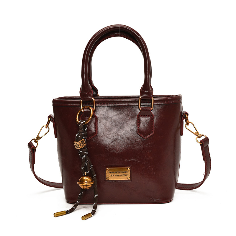 Retro versátil simple bolso de cubo portátil 2025 nuevo bolso de mujer nicho manuscrito de moda coreana bolso de hombro