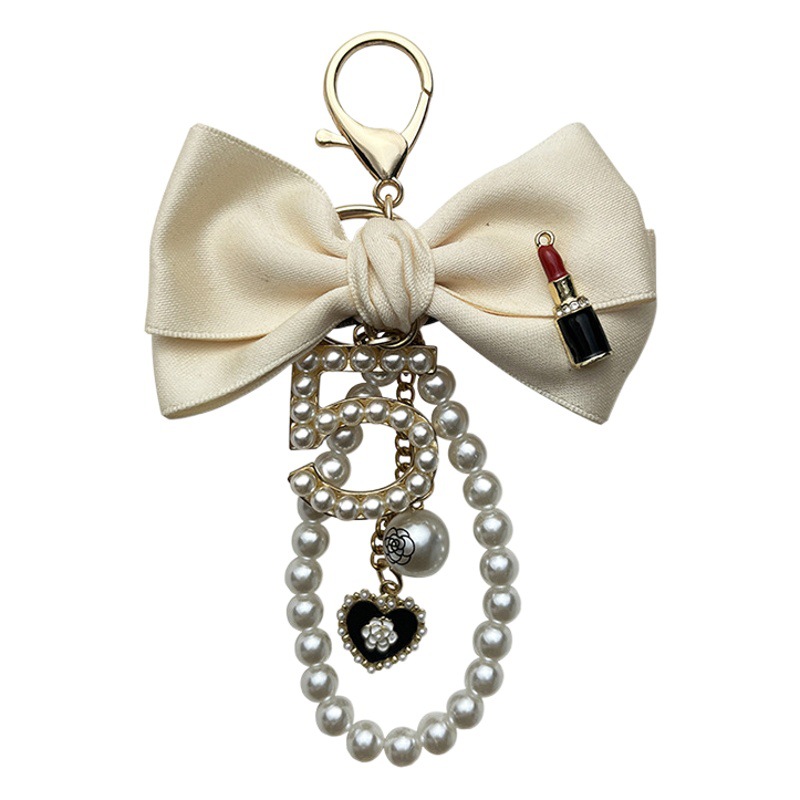 Gran 5-palabra arco lápiz labial llavero personalizado perla cadena de moda de las mujeres bolsa colgante decorativo coche clave