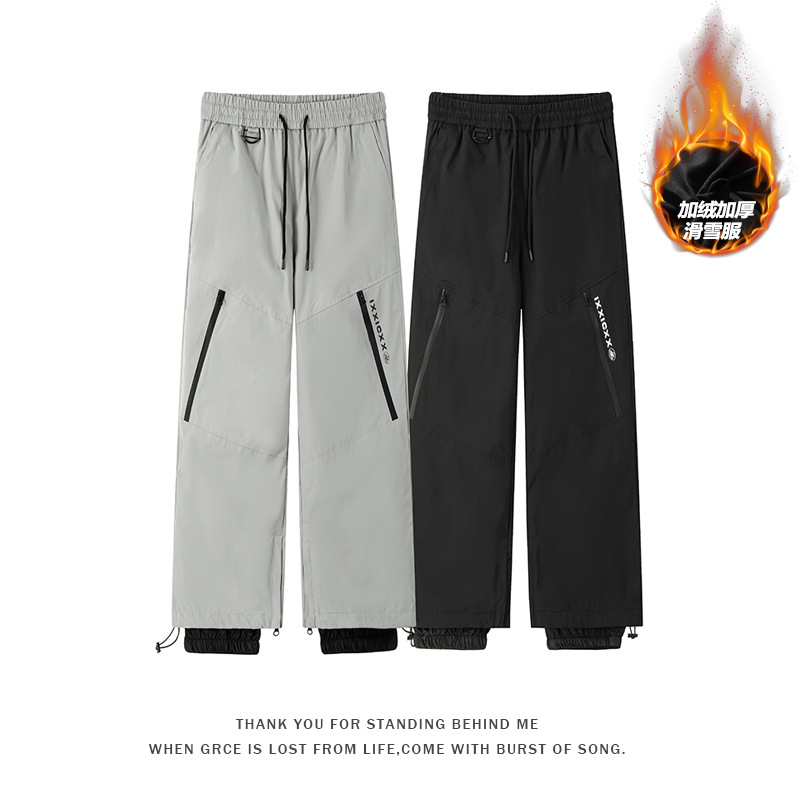 In stock ski pants with a snow skirt, windproof, water-repellent, loose fit, unisex, suitable for outdoor hiking.