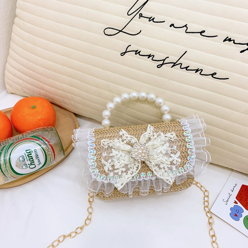 2025 nuevo regalo para niñas para niñas jardín de infantes Día de los niños arco de perla tela de paja bolso de hombro