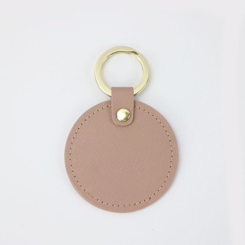 Llavero redondo de cuero genuino personalizado creativo simple colgante hombres y mujeres pequeño exquisito pequeño regalo al por mayor todo a juego