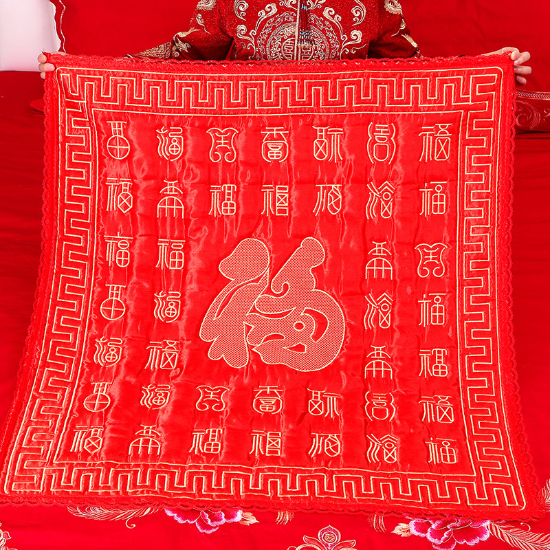 Wedding essentials: bridal "Zuo Fu" quilt, celebratory wedding quilt for the couple, heirloom "Bai Fu" cushion, and embroidered decorations for the bride's new home.