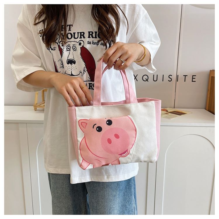 Cute cartoon printed small bag, 2024 summer new style hand-held piggy girl handbag, student storage canvas bag full figure